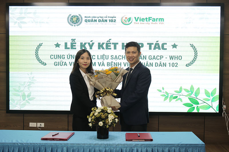 Đại diện Bệnh viện YHCT Quân Dân 102 tặng hoa cho đại diện Trung tâm Dược liệu Vietfarm